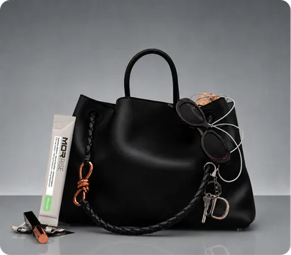 Rise sachet tucked into a black handbag with sunglasses and keys