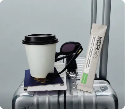 Rise sachet packed on a suitcase with coffee and passport